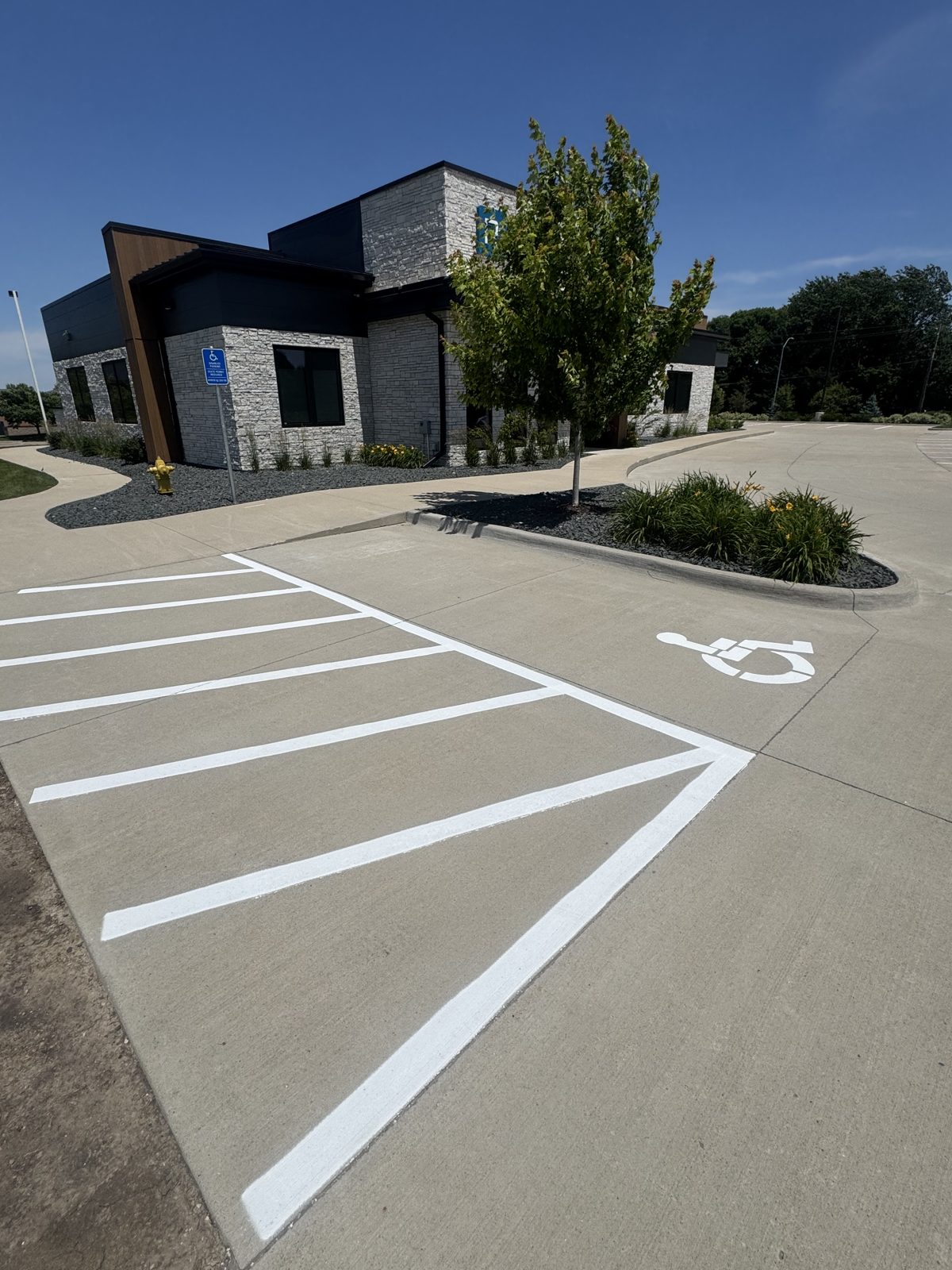 New parking lot striping with a fresh ADA handicap stall and access aisle in Iowa