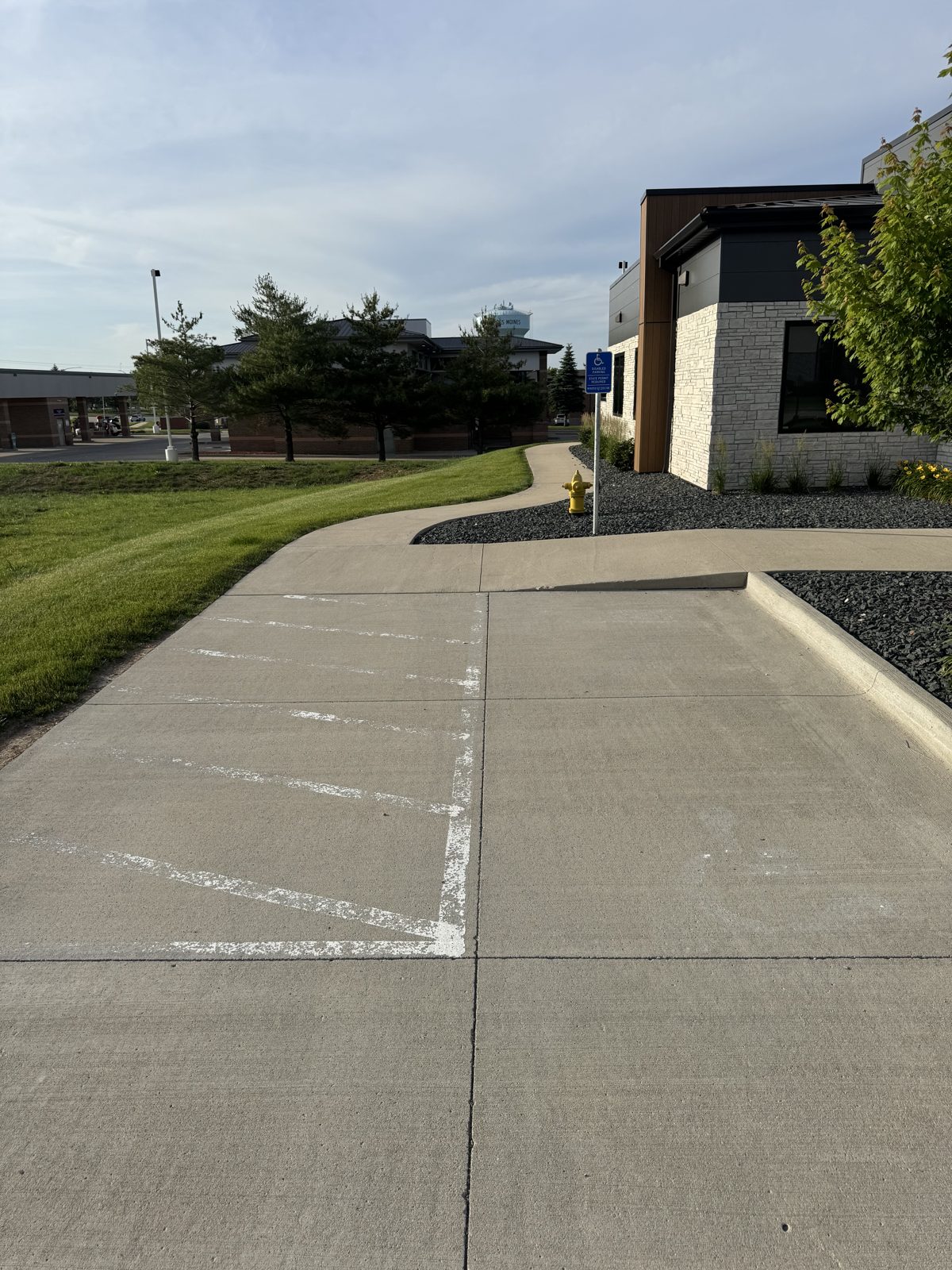 Bare faded lot with no visible stalls before striping at a commercial building in Iowa