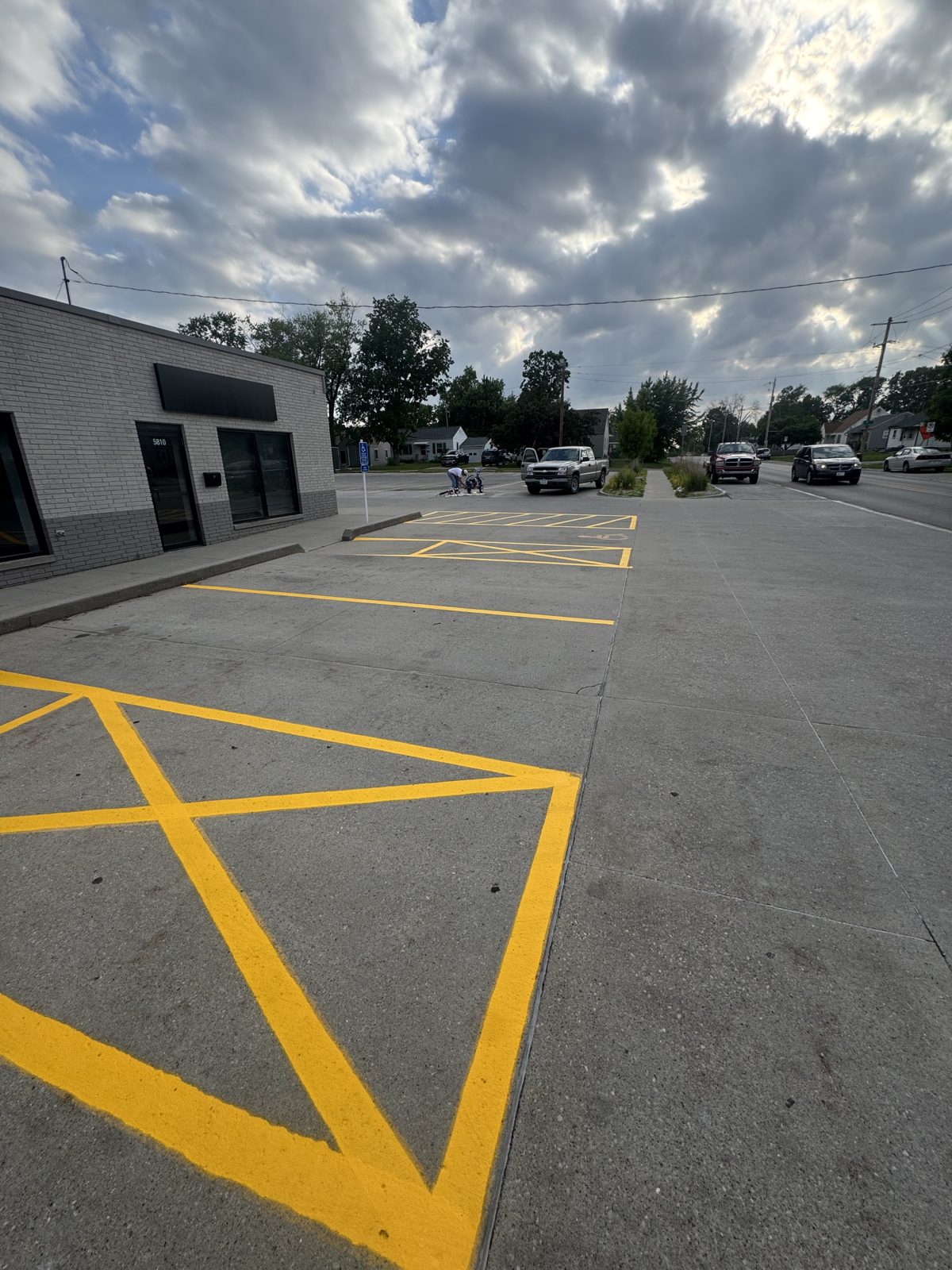 Re-striped retail parking lot with clean yellow lines in Iowa